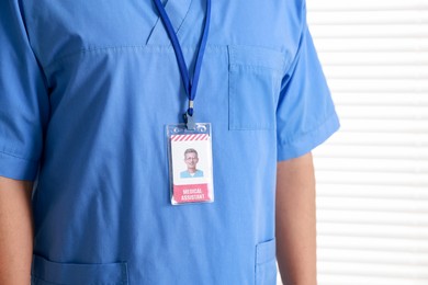 Photo of Medical assistant with badge on white background, closeup