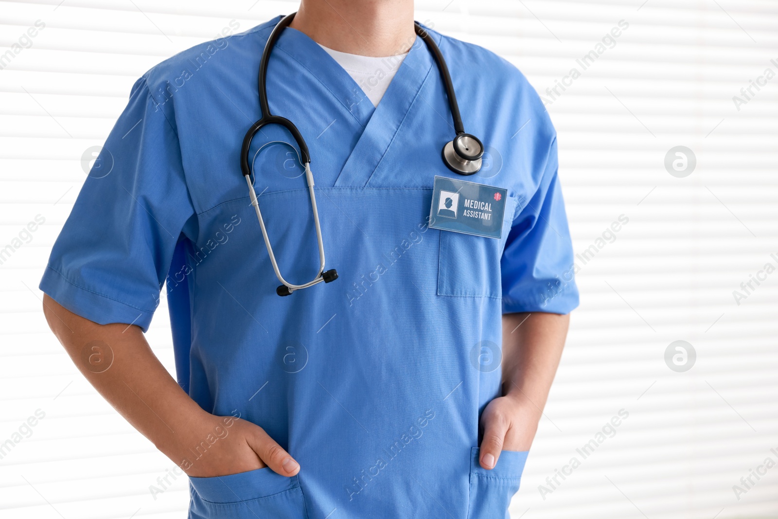 Photo of Medical assistant with badge on white background, closeup