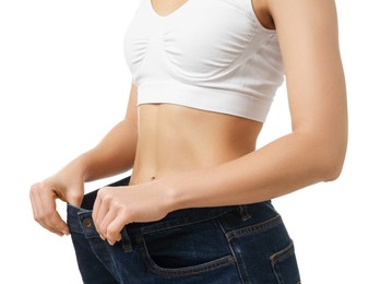 Photo of Weight loss. Woman wearing big jeans on white background, closeup