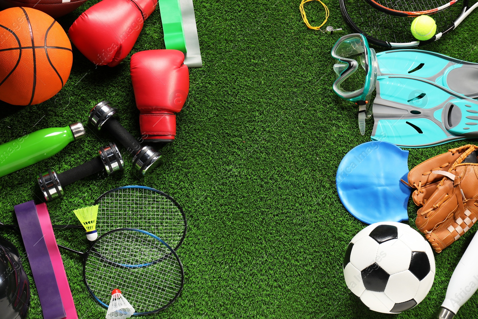 Photo of Different sports equipment on artificial grass, flat lay. Space for text