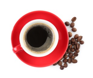 Photo of Red cup of aromatic coffee, saucer and beans isolated on white, top view