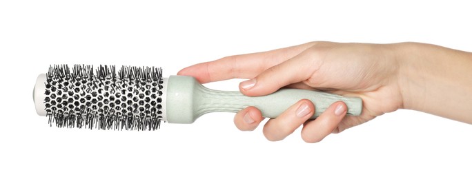 Photo of Woman with round hair brush on white background, closeup