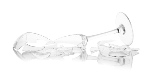 Photo of Pieces of broken wine glass isolated on white