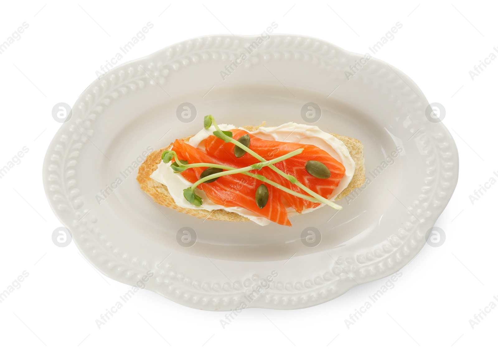 Photo of Delicious bruschetta with cream cheese and salmon isolated on white, top view