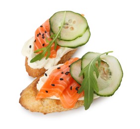 Photo of Delicious bruschette with cream cheese, salmon and cucumber isolated on white