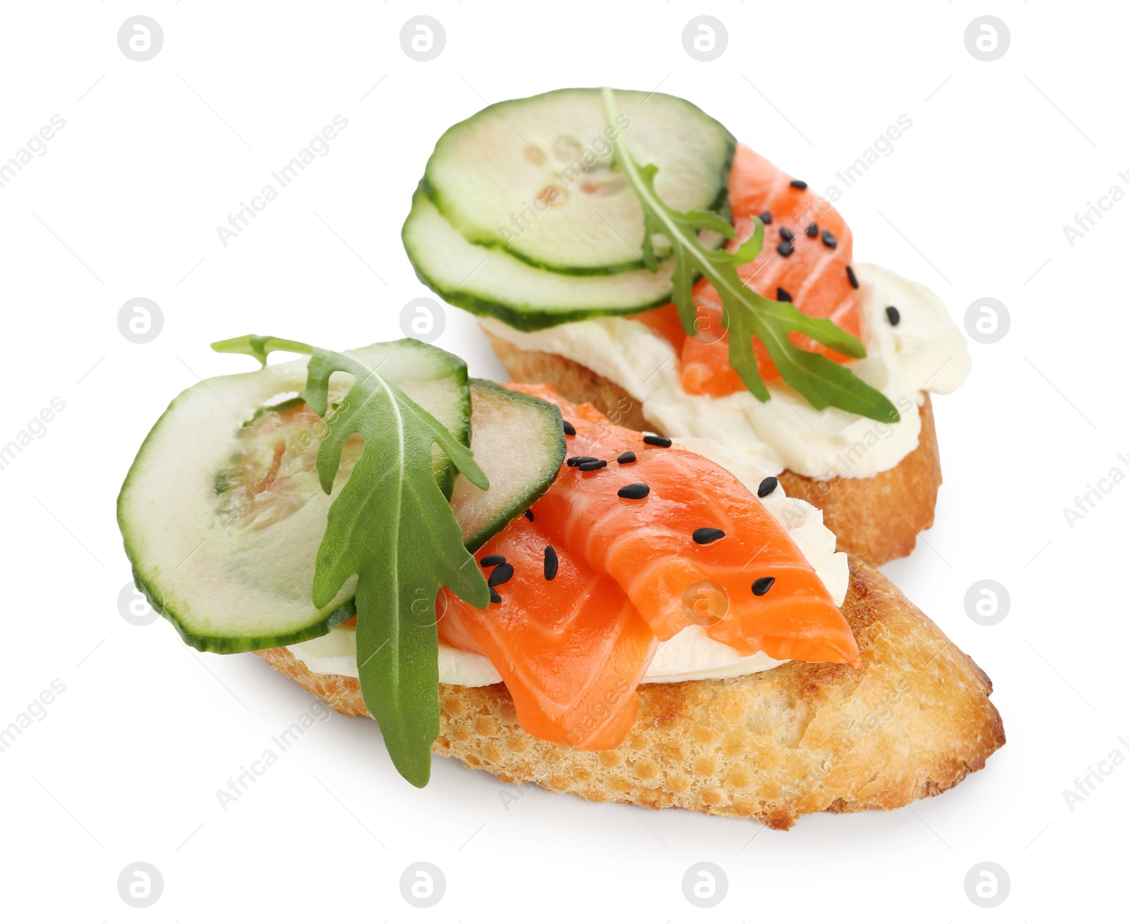 Photo of Delicious bruschette with cream cheese, salmon and cucumber isolated on white