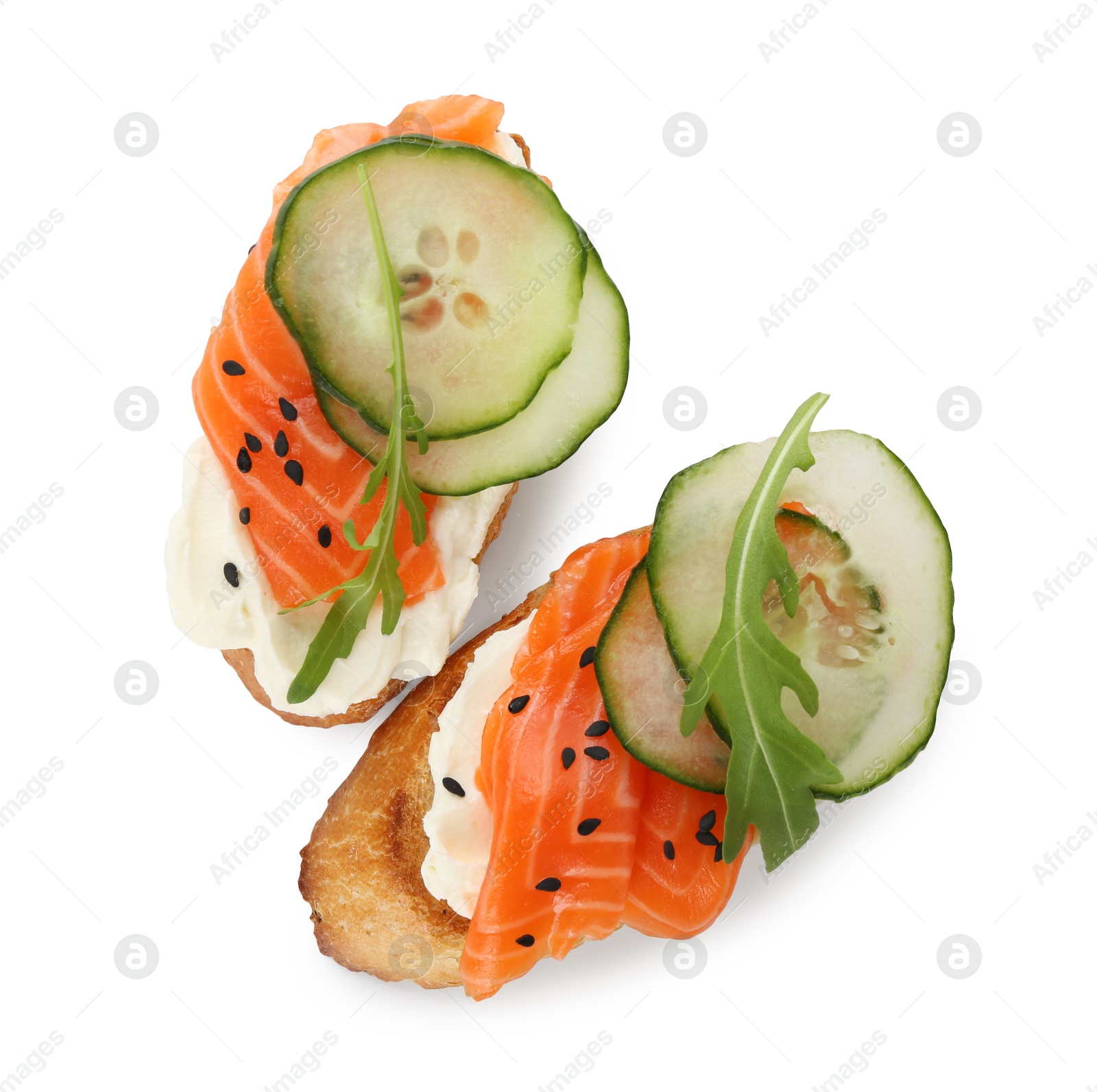 Photo of Delicious bruschette with cream cheese, salmon and cucumber isolated on white, top view