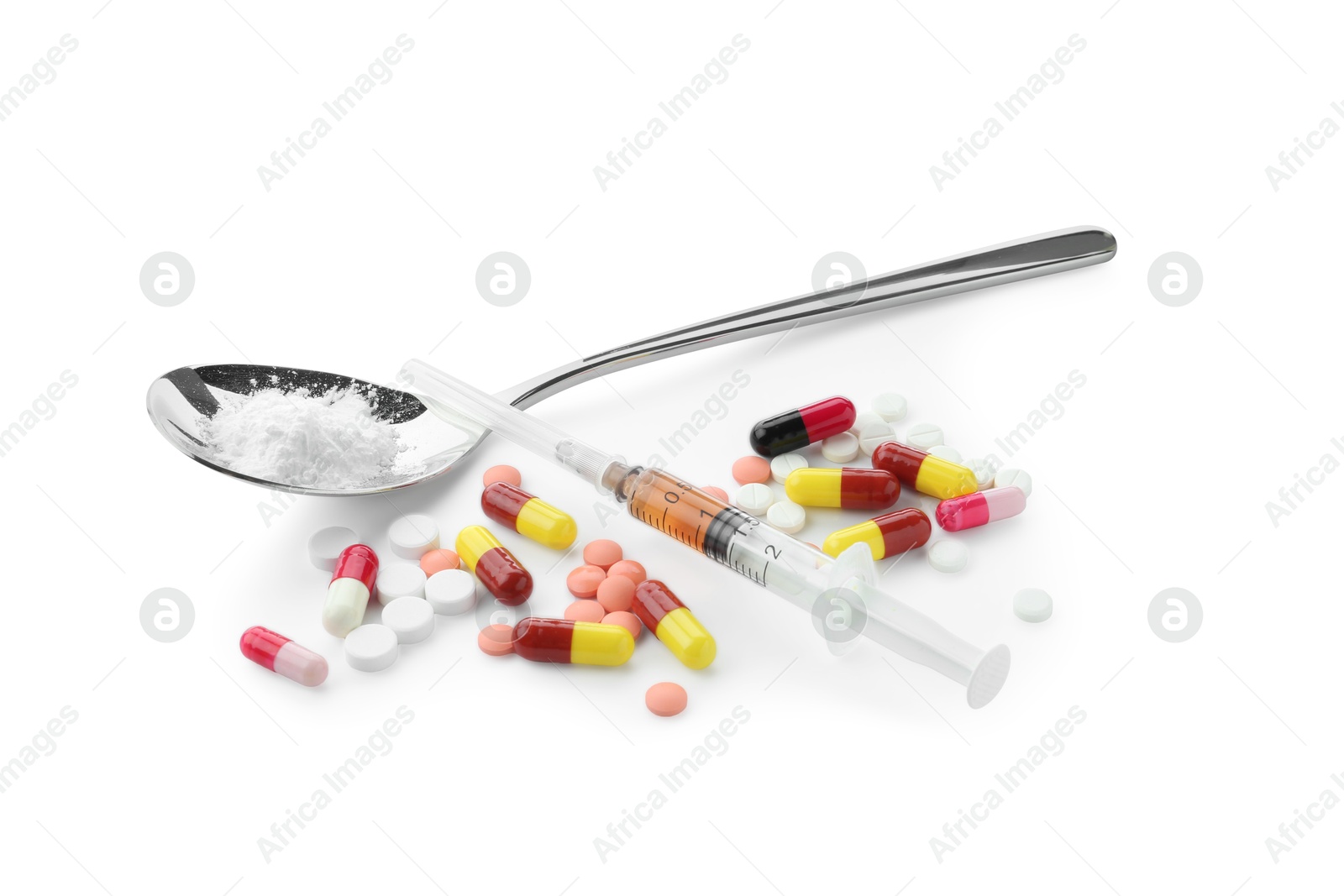 Photo of Drug addiction. Different pills, spoon with powder and syringe isolated on white