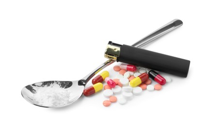 Photo of Drug addiction. Different pills, spoon with powder and cigarette lighter isolated on white