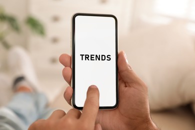 Image of New trends. Man using mobile phone indoors, closeup