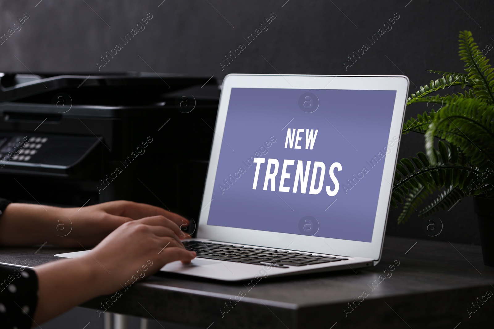 Image of New trends. Woman using laptop at table in office, closeup