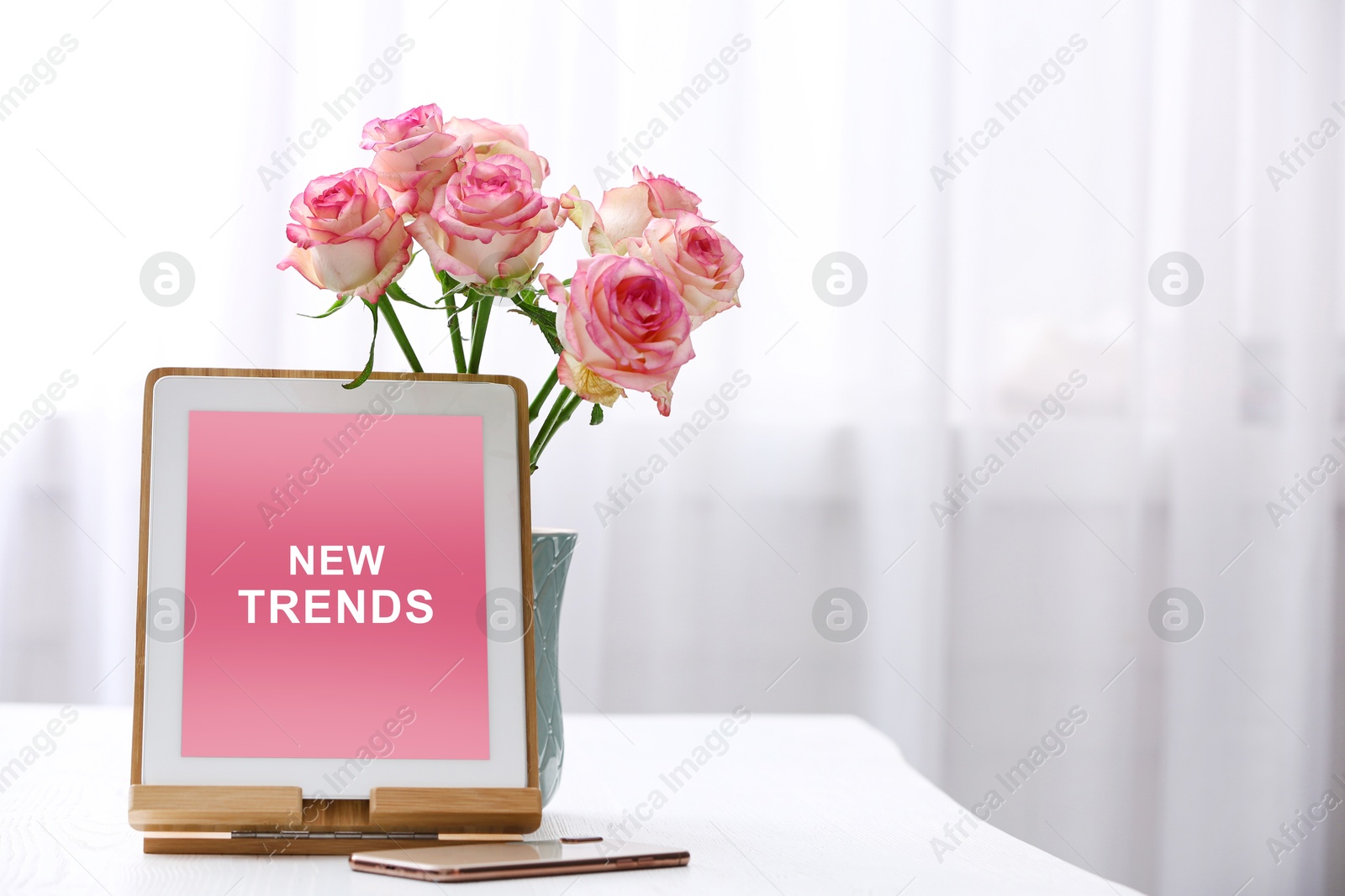 Image of New trends. Tablet, smartphone and flowers indoors