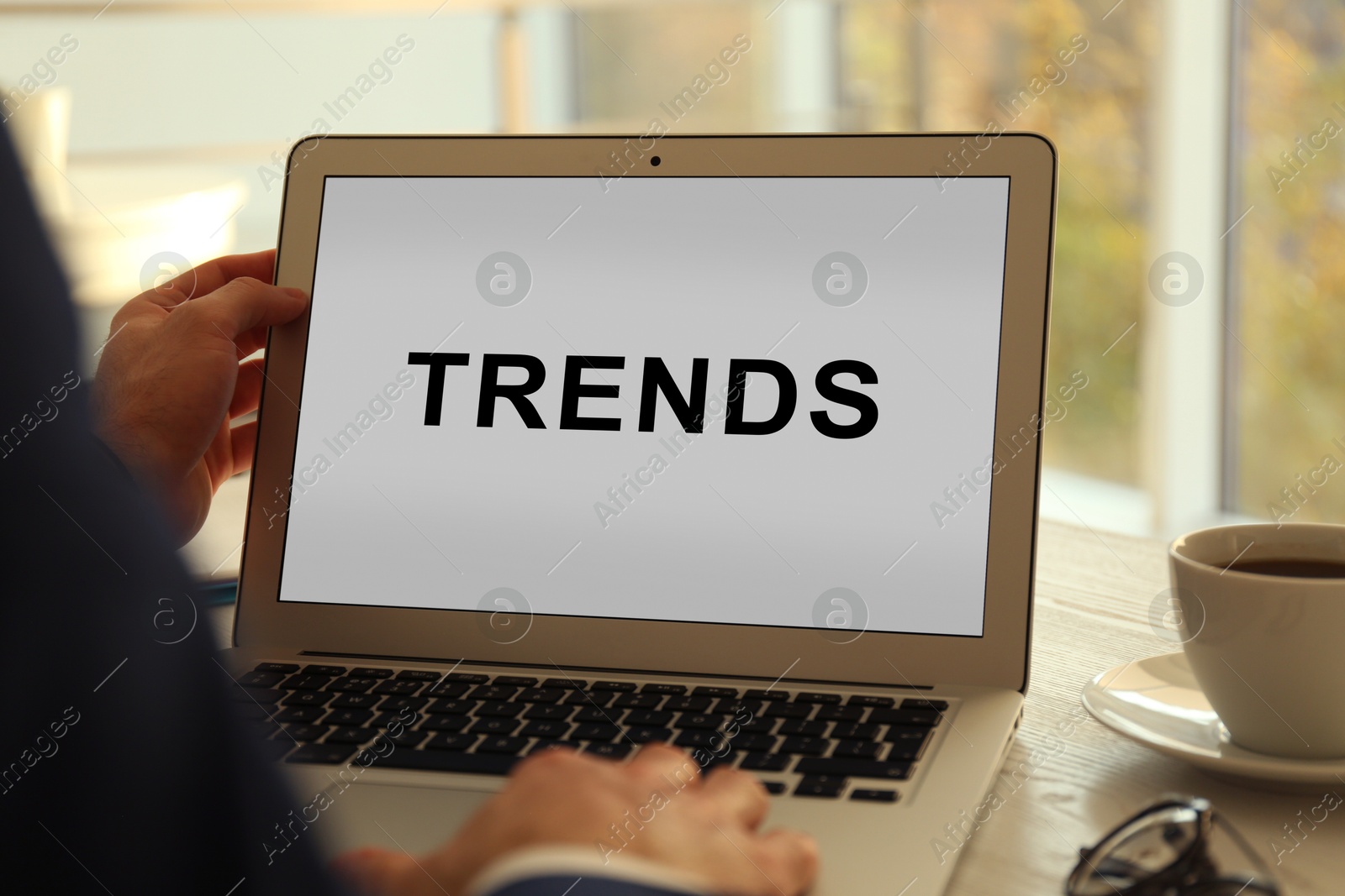 Image of New Trends. Man using laptop at table indoors, closeup