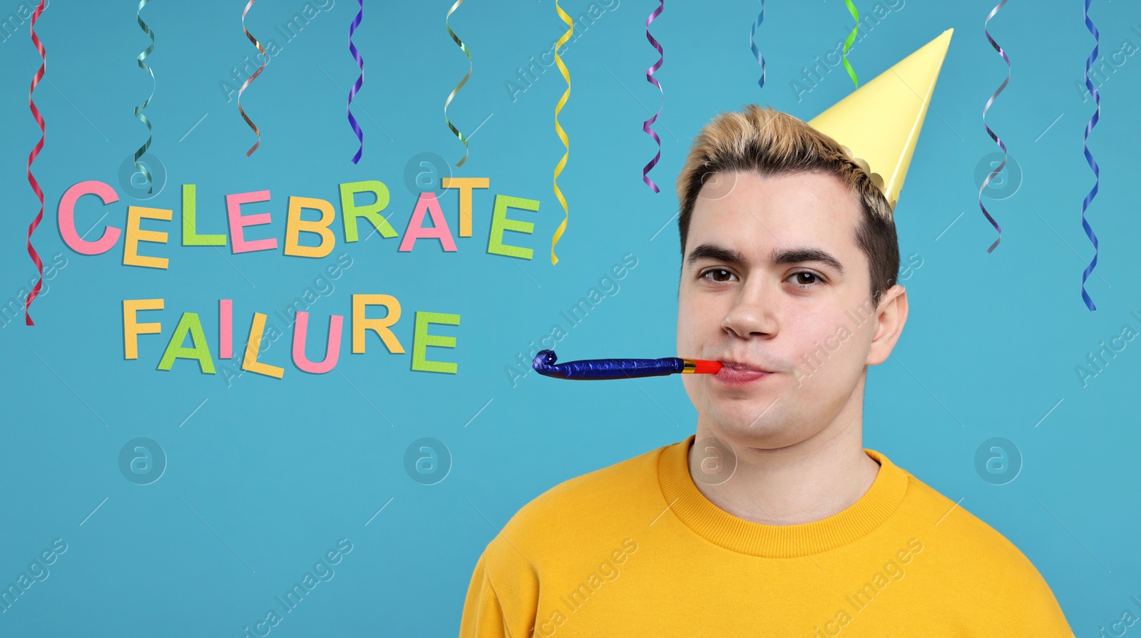 Image of Celebrate failure. Young man with party hat and blower on light blue background. Banner design