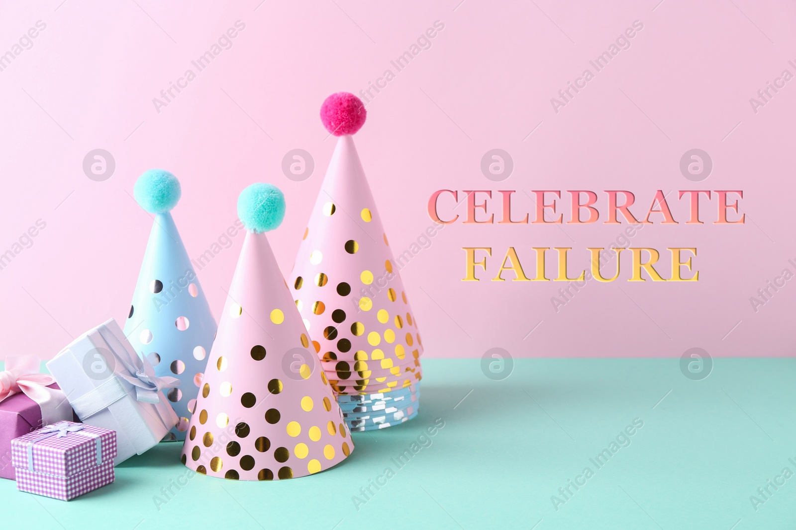 Image of Celebrate failure. Party hats and gift boxes on color background