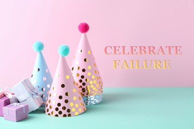 Image of Celebrate failure. Party hats and gift boxes on color background