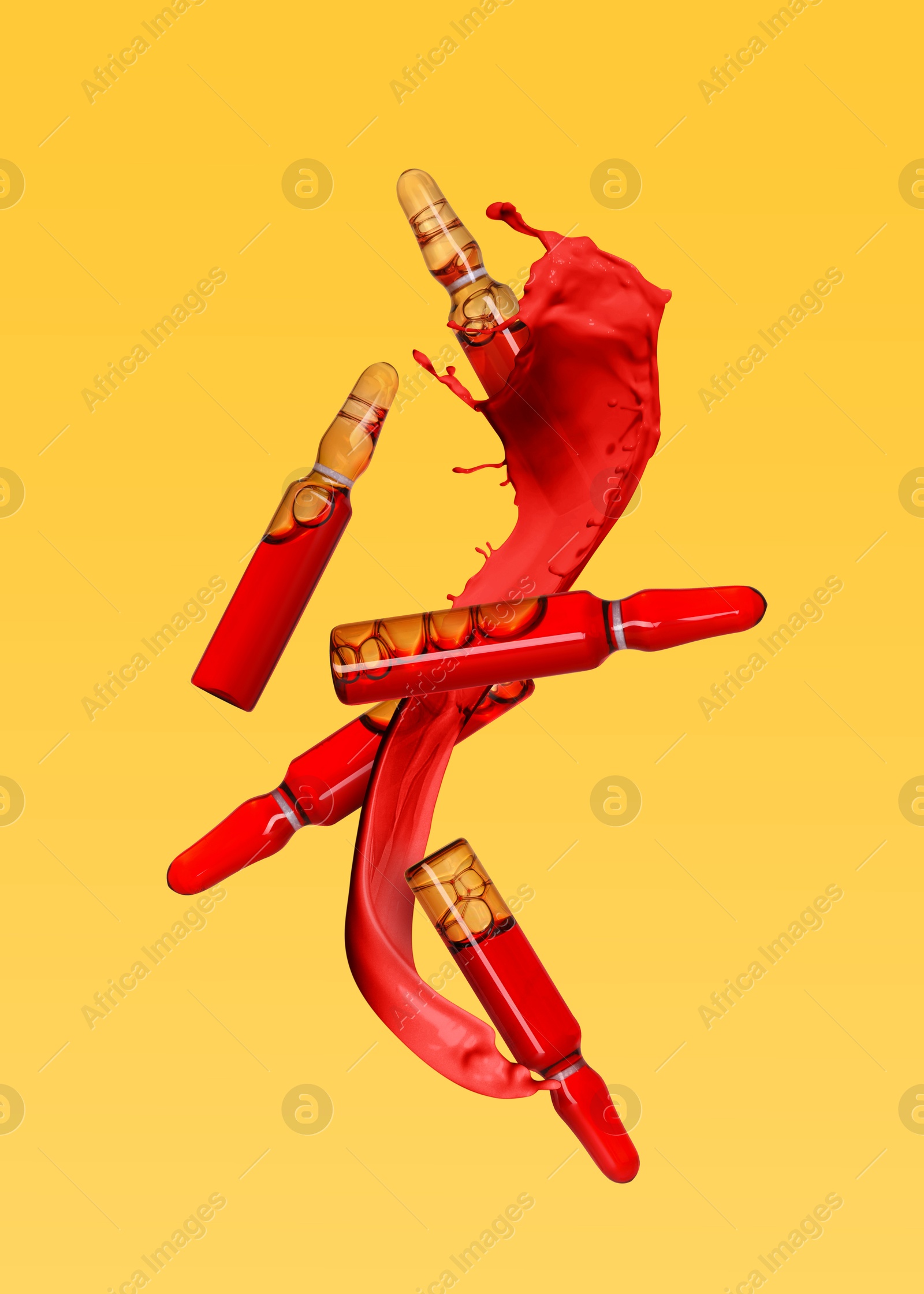 Image of Ampoules and splashing liquid in air on orange background