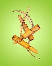 Image of Ampoules and splashing liquid in air on green background