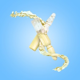 Image of Ampoules and splash of liquid in air on light blue background