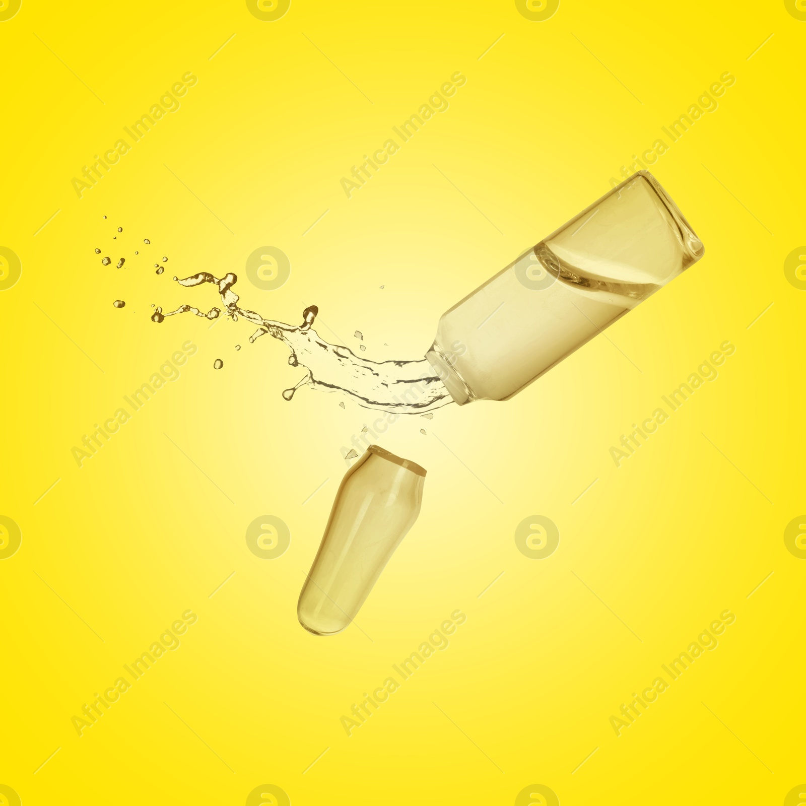 Image of Open ampoule with splashing liquid in air on yellow background