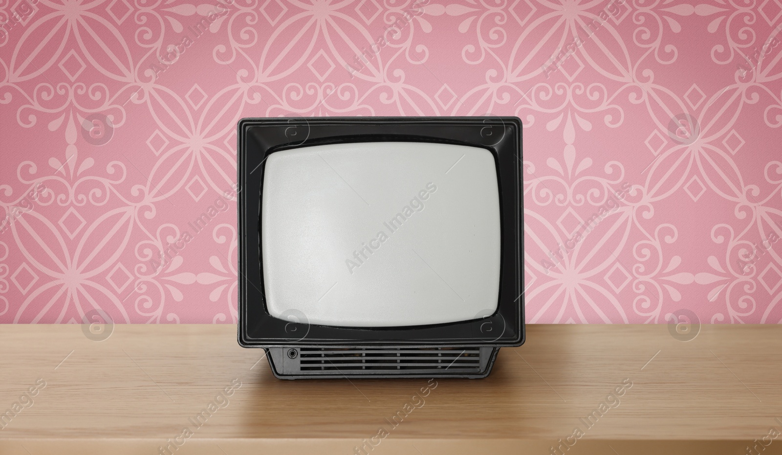 Image of Retro TV on wooden table near wall with vintage style wallpaper. Banner design