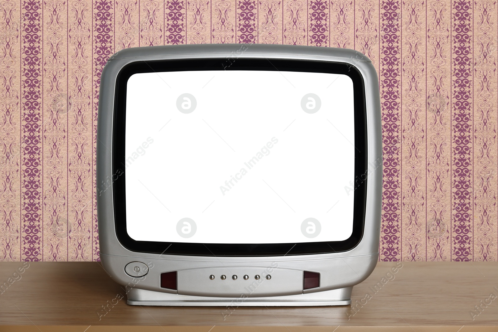 Image of Retro TV on wooden table near wall with vintage style wallpaper