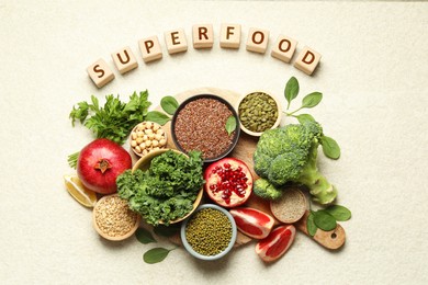 Image of Superfood. Different healthy food products and cubes on light table, flat lay