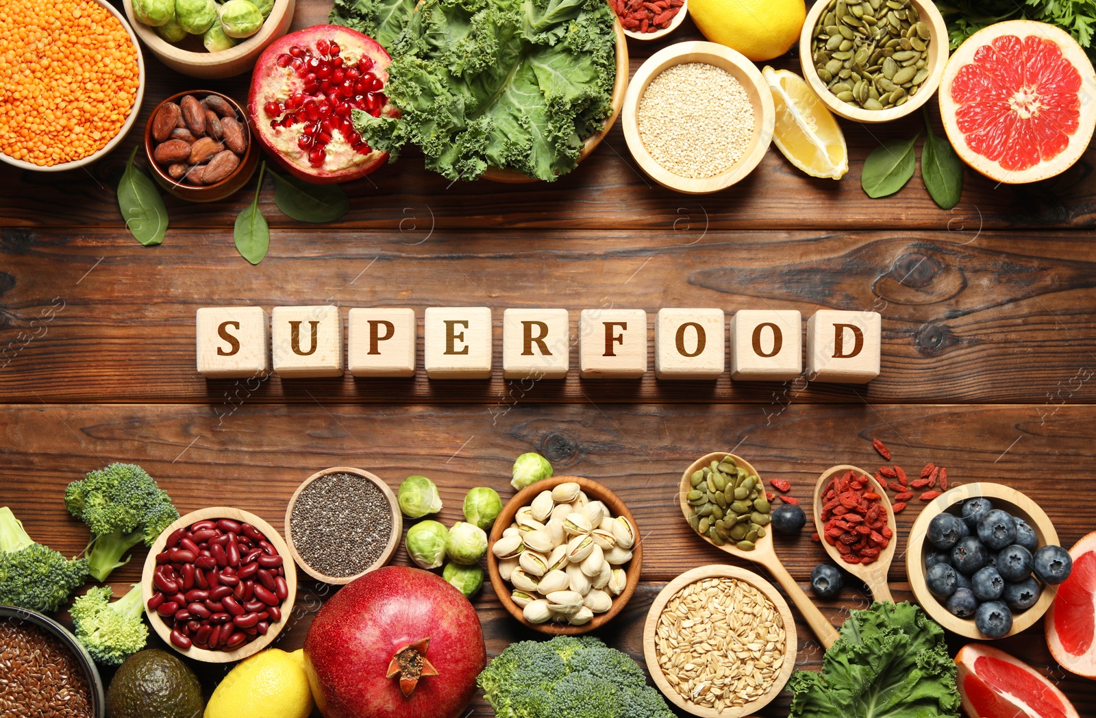 Image of Superfood. Different healthy food products and cubes on wooden table, flat lay