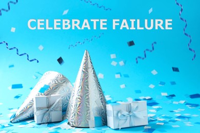 Image of Celebrate failure. Gift boxes and party hats under falling confetti and streamers on light blue background