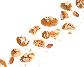 Image of Yummy nut cookies with almond petals in air on white background