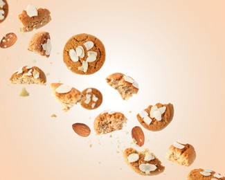 Image of Yummy nut cookies with almond petals in air on beige background