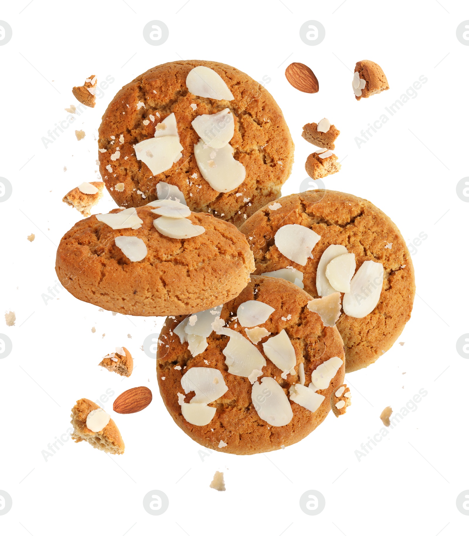 Image of Yummy nut cookies with almond petals in air on white background