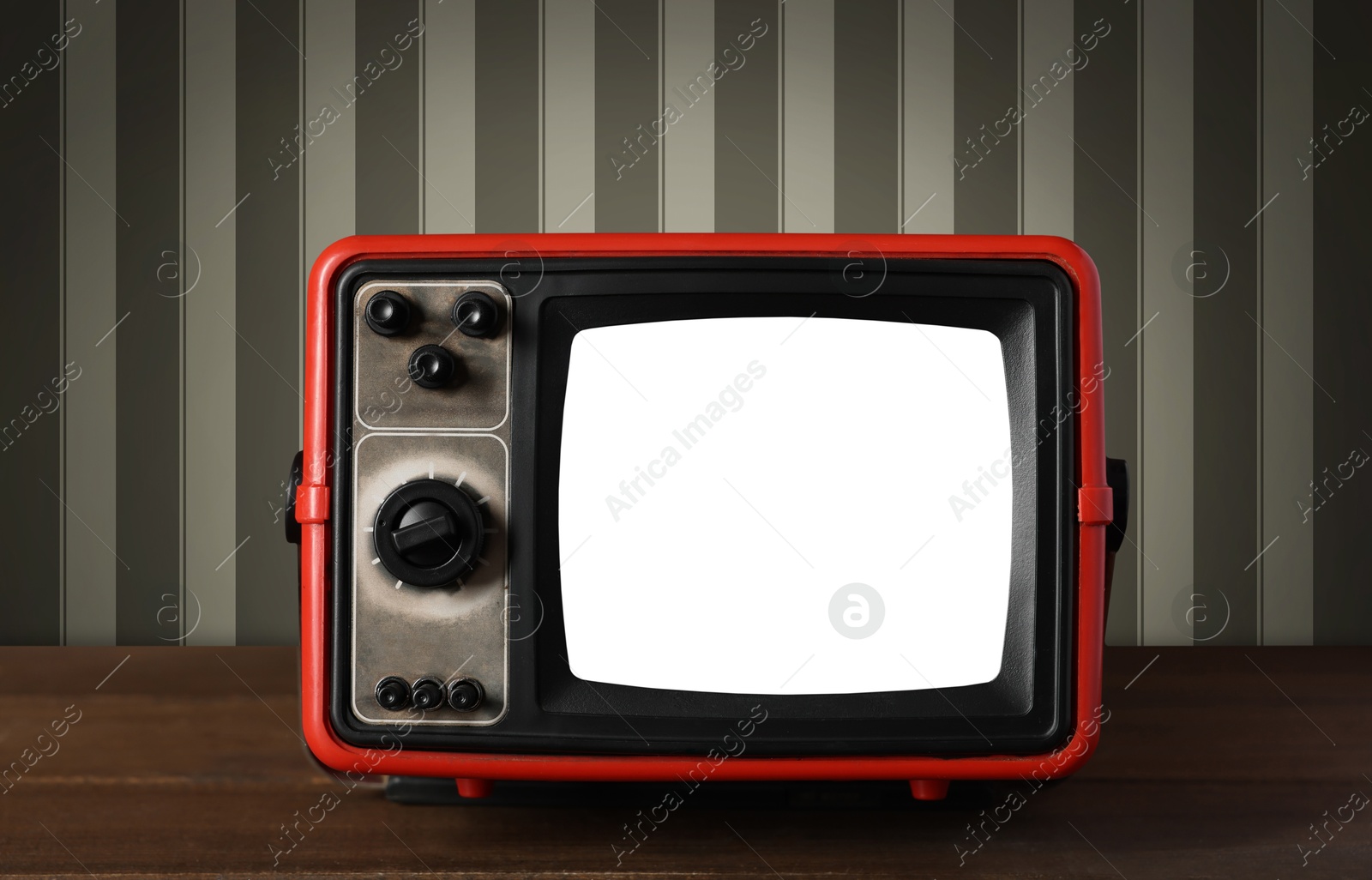 Image of Retro TV on wooden table near wall with vintage style wallpaper