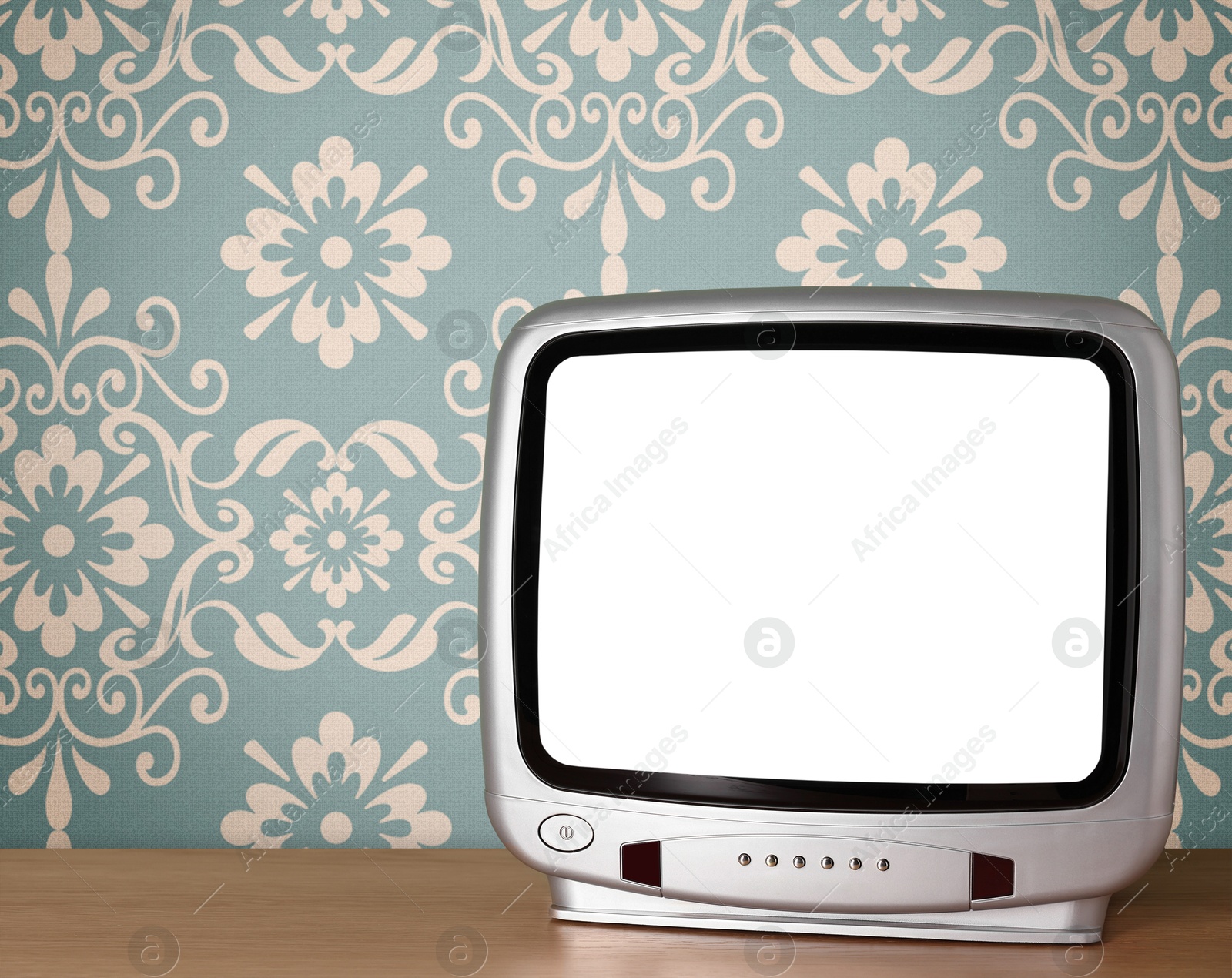 Image of Retro TV on wooden table near wall with vintage style wallpaper. Space for text