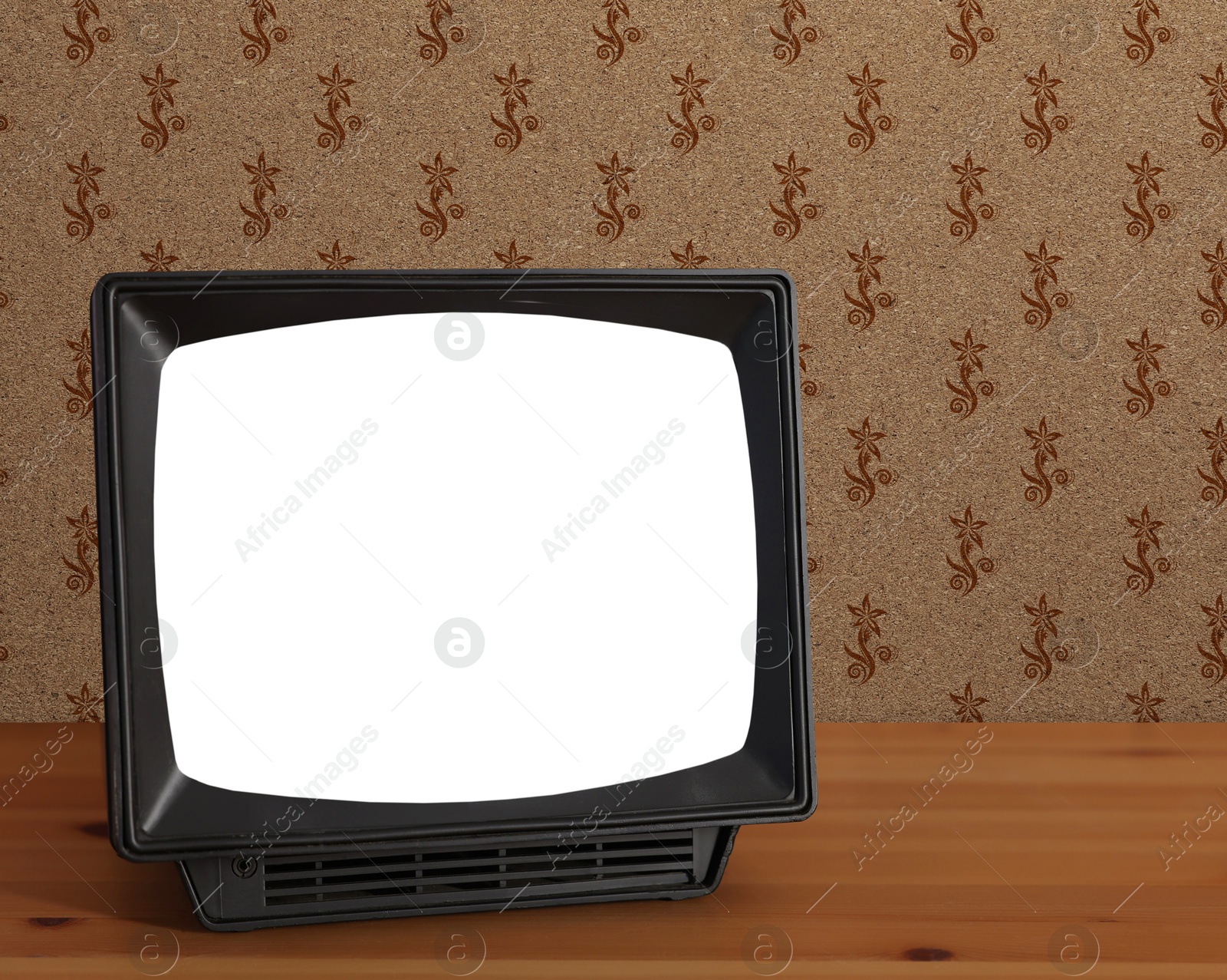 Image of Retro TV on wooden table near wall with vintage style wallpaper. Space for text