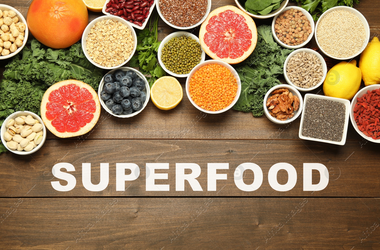 Image of Superfood. Different healthy food products on wooden table, flat lay