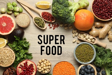 Image of Superfood. Different healthy food products on wooden table, flat lay