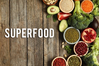 Image of Superfood. Different healthy food products on wooden table, flat lay