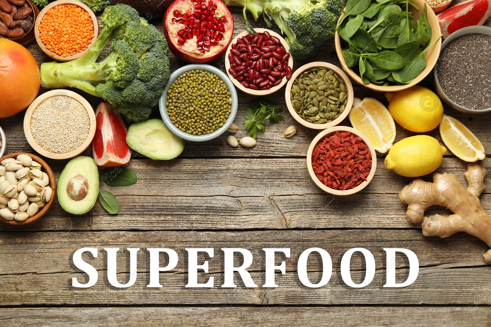 Image of Superfood. Different healthy food products on wooden table, flat lay