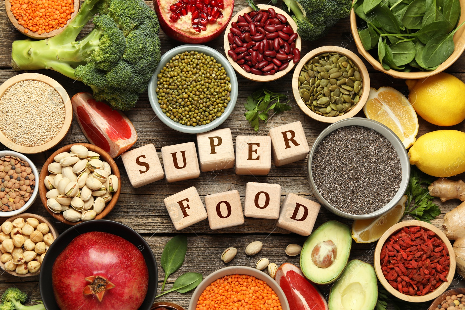 Image of Superfood. Different healthy food products and cubes on wooden table, flat lay