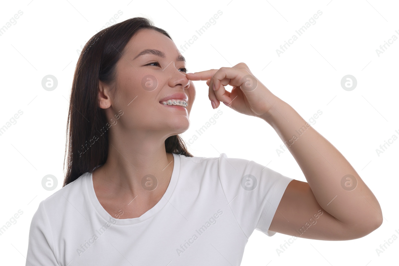 Photo of Young woman touching her nose on white background