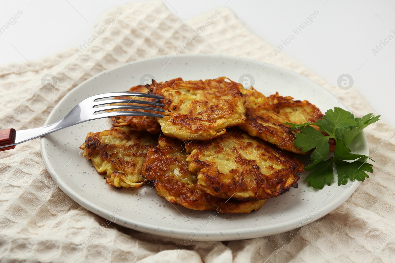 Photo of Delicious potato pancakes served on table, closeup