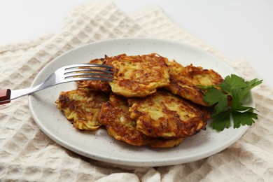 Photo of Delicious potato pancakes served on table, closeup