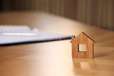 Photo of Property insurance. House figure on wooden table