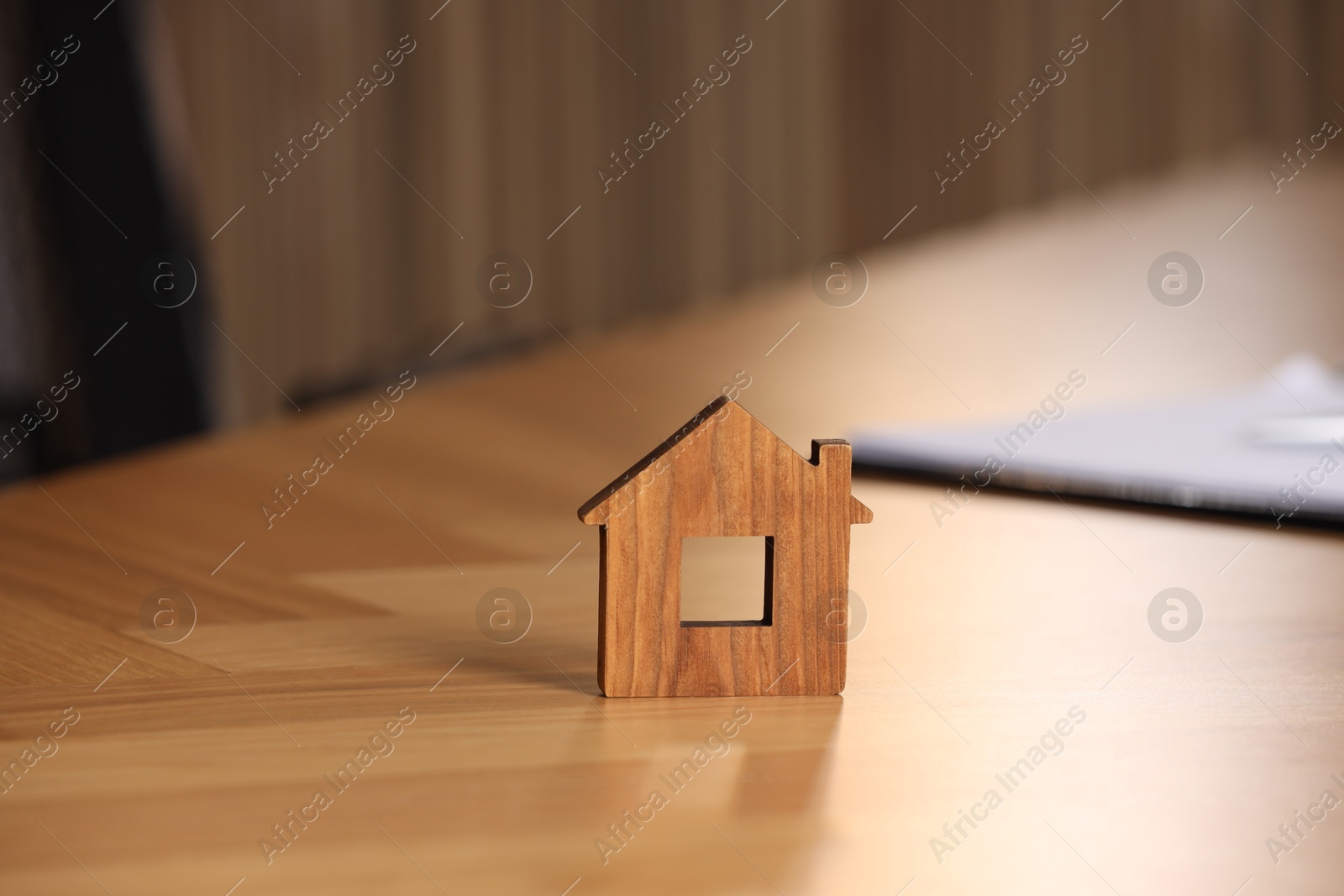 Photo of Property insurance. House figure on wooden table