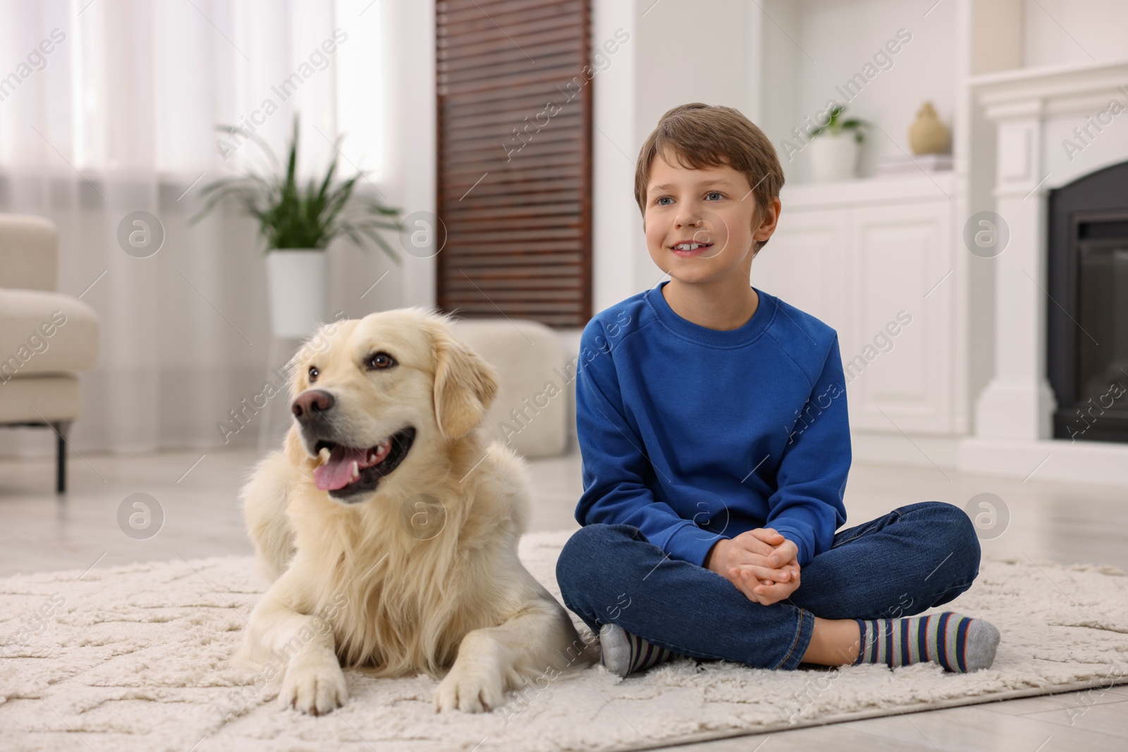 Photo of Boy with his cute dog at home