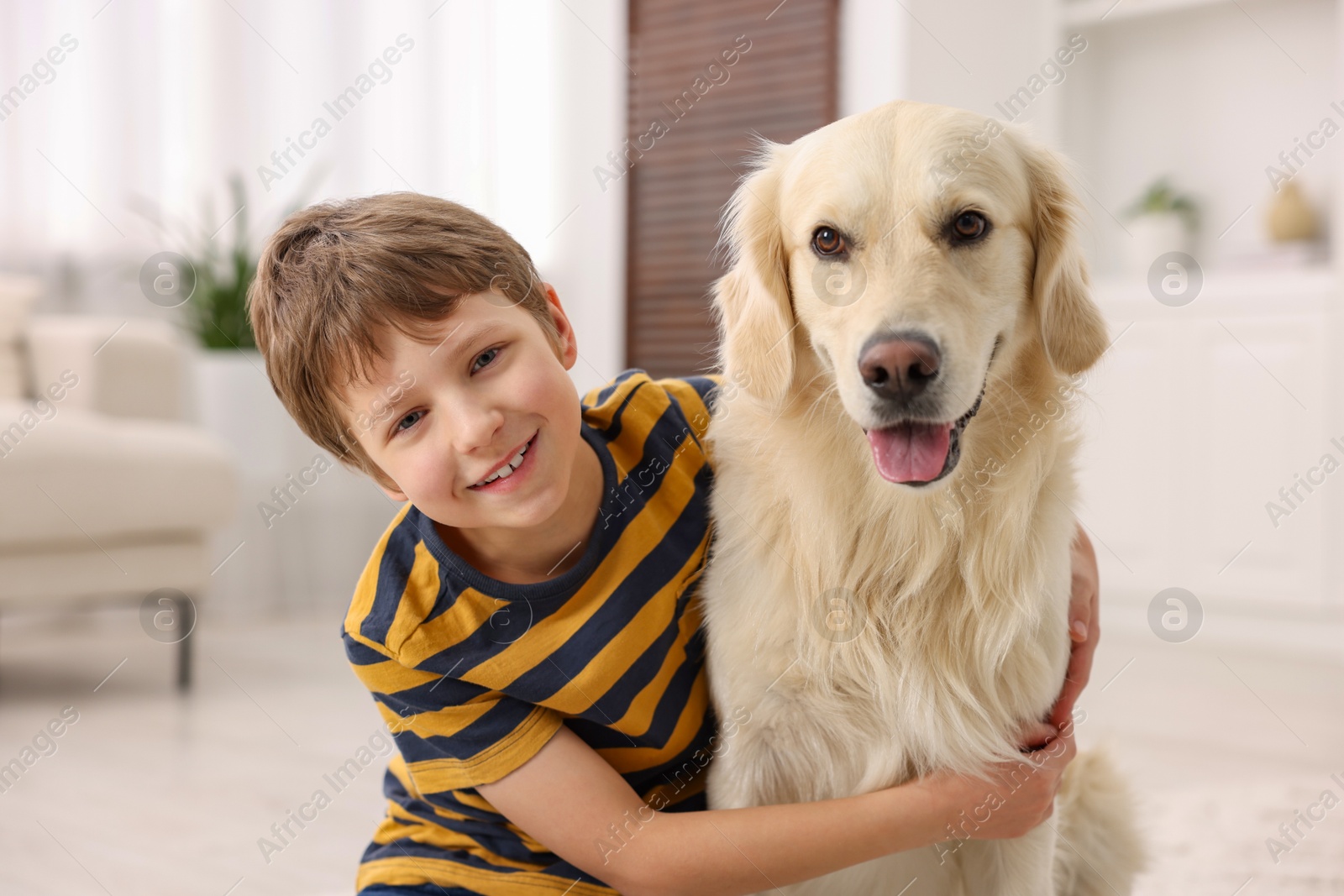 Photo of Boy with his cute dog at home