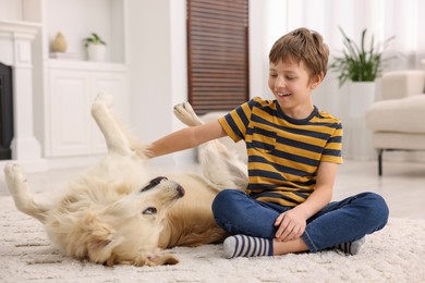 Photo of Boy playing with his cute dog at home