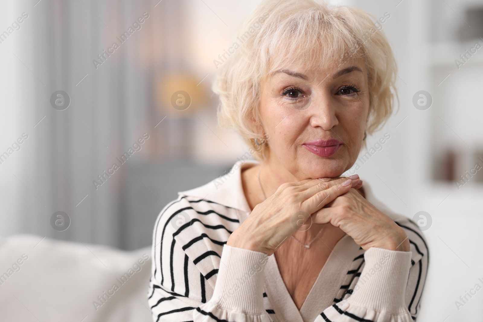 Photo of Portrait of beautiful grandmother at home. Space for text