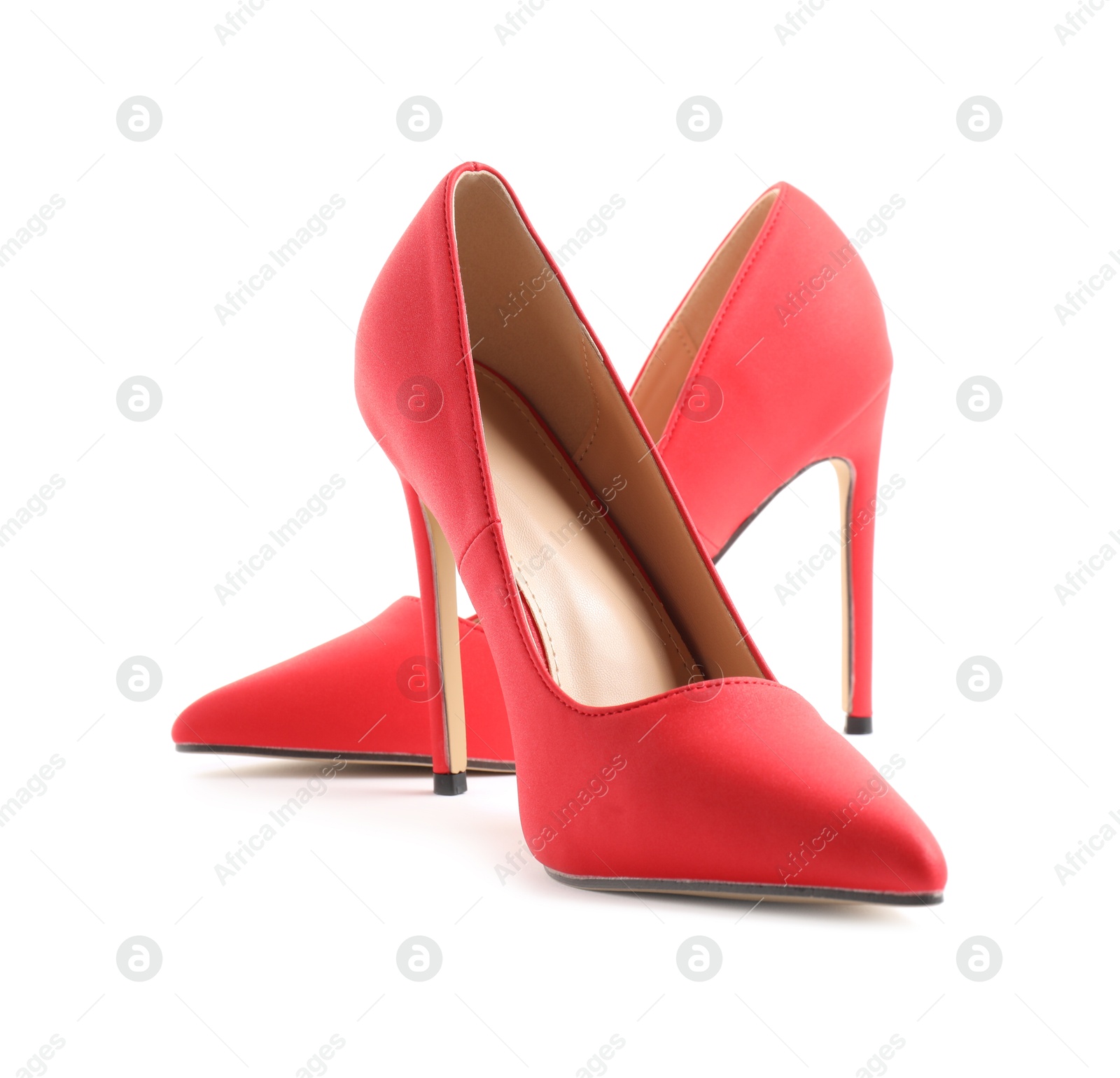 Photo of Pair of red high-heeled shoes isolated on white